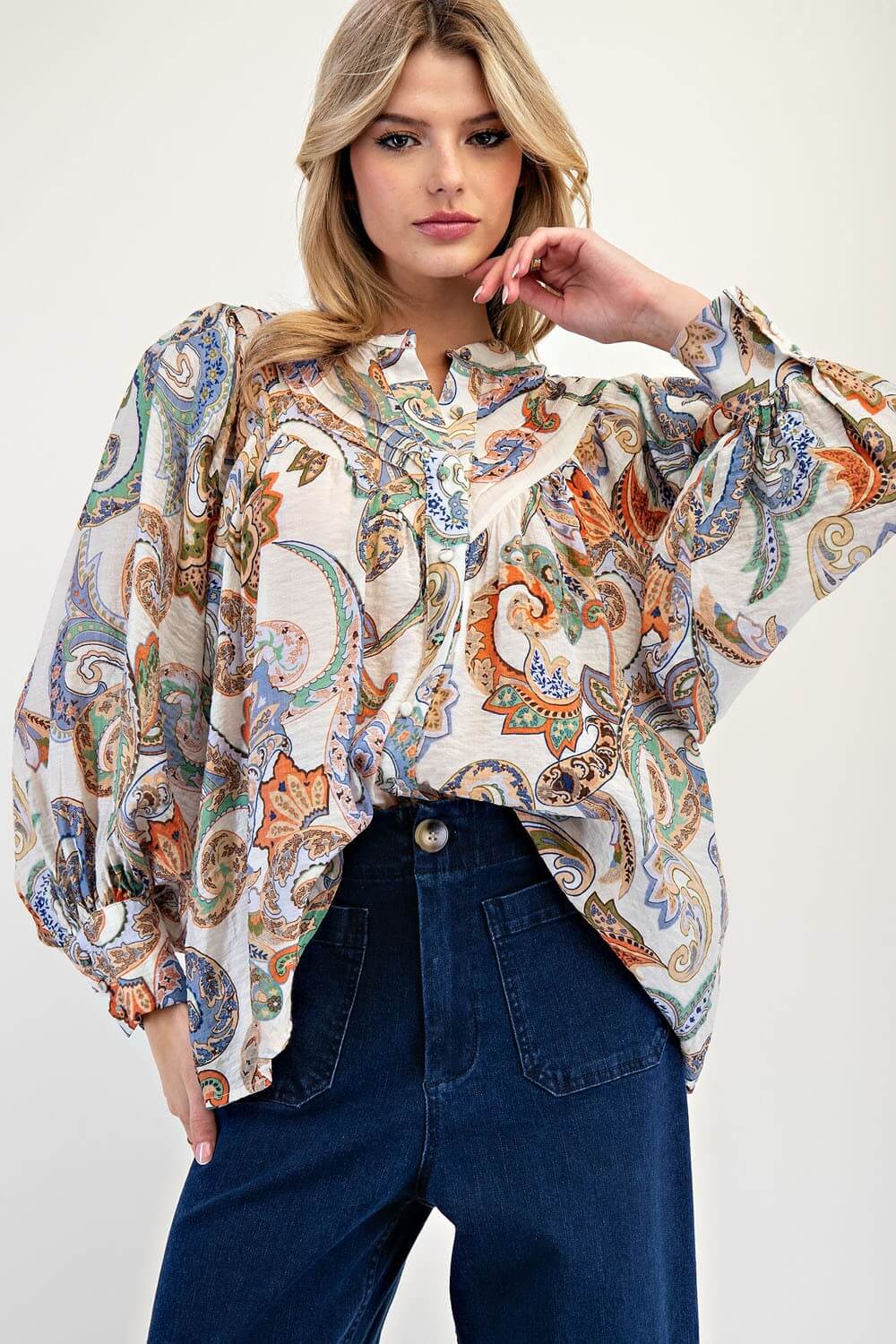 Paisley print balloon sleeve blouse. Blue, green, orange, brown are the colors in the shirt