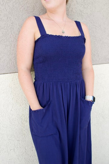blue jumpsuit with smocked top and front pockets