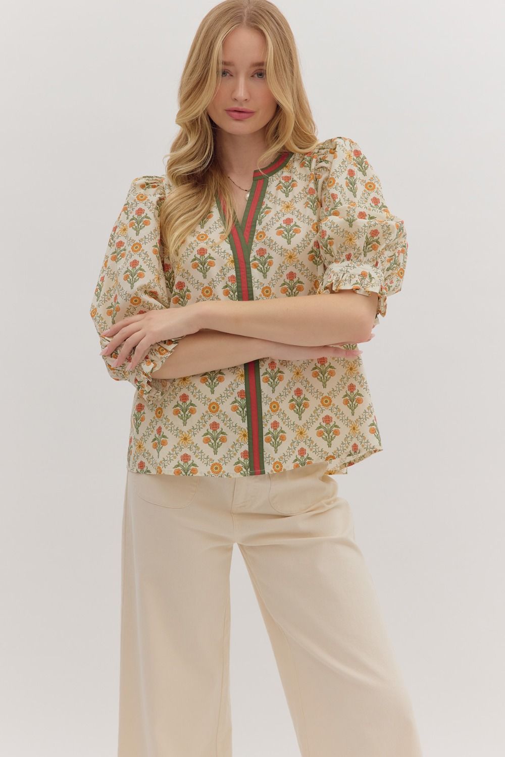 cream floral blouse with orange and green stripe down the middle