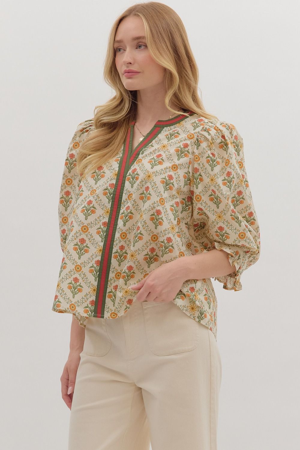 cream floral blouse with orange and green stripe down the middle