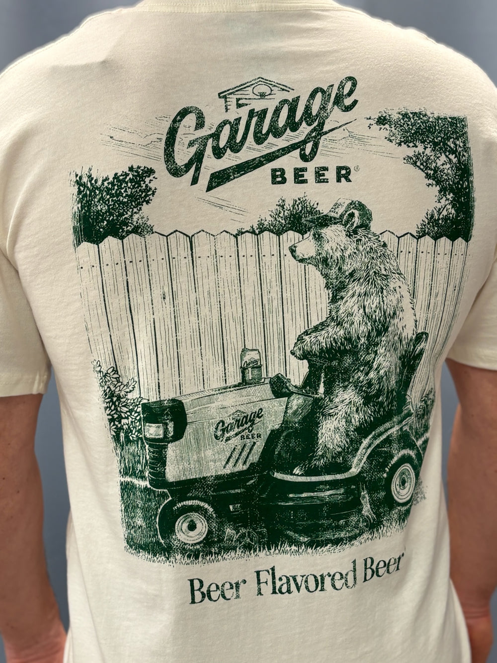 T-shirt with a bear driving a tractor and 'Garage Beer' text on the back.