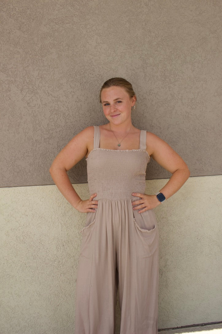beige jumpsuit with smocked top and front pockets 