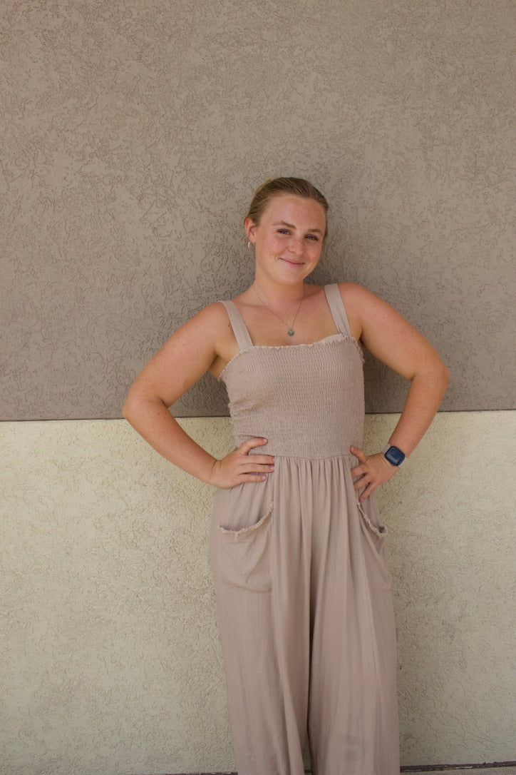 beige jumpsuit with smocked top and front pockets 