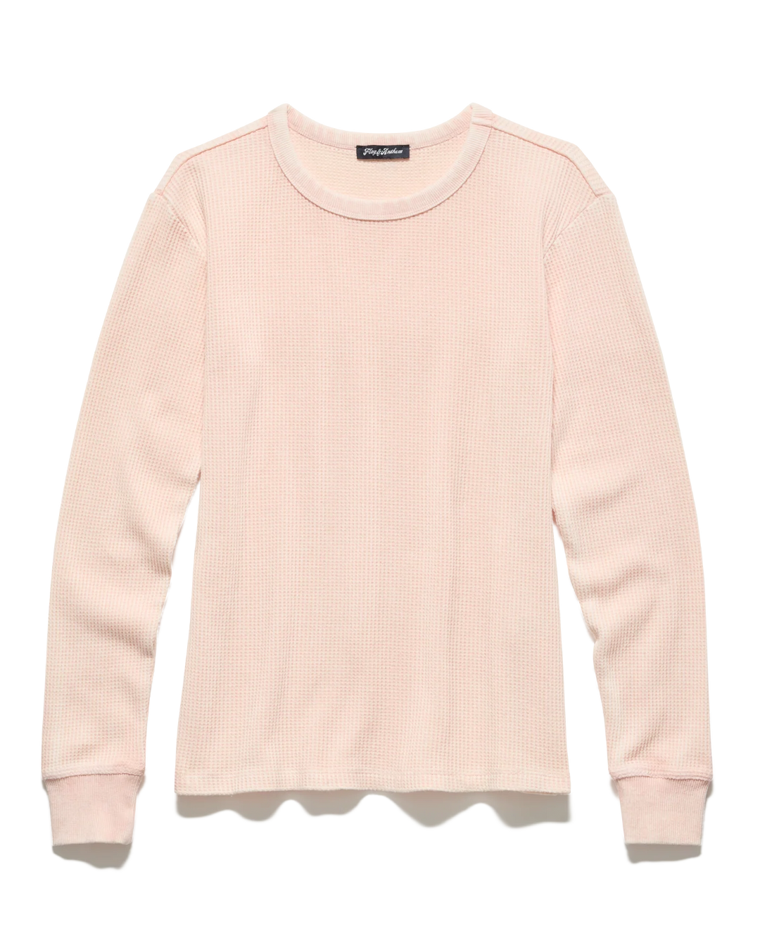 Pink ribbed sweater on a white background