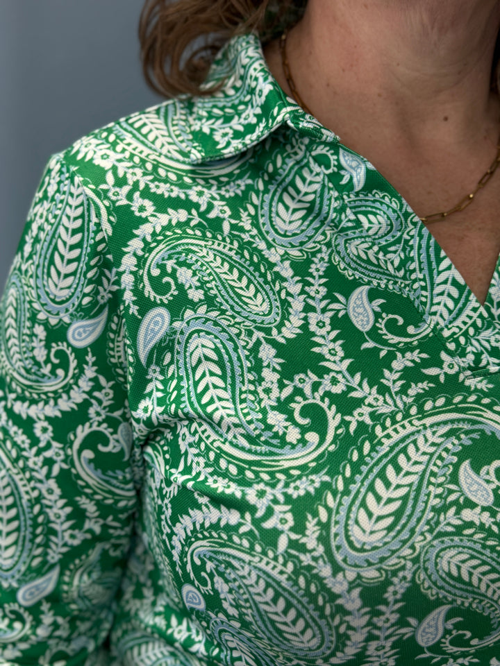 Green shirt with white paisley pattern worn by a person