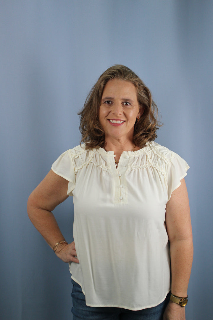 RUFFLED YOKE SHORT SLEEVE HENLEY BLOUSE