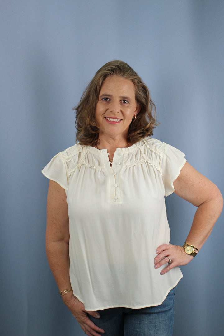 RUFFLED YOKE SHORT SLEEVE HENLEY BLOUSE