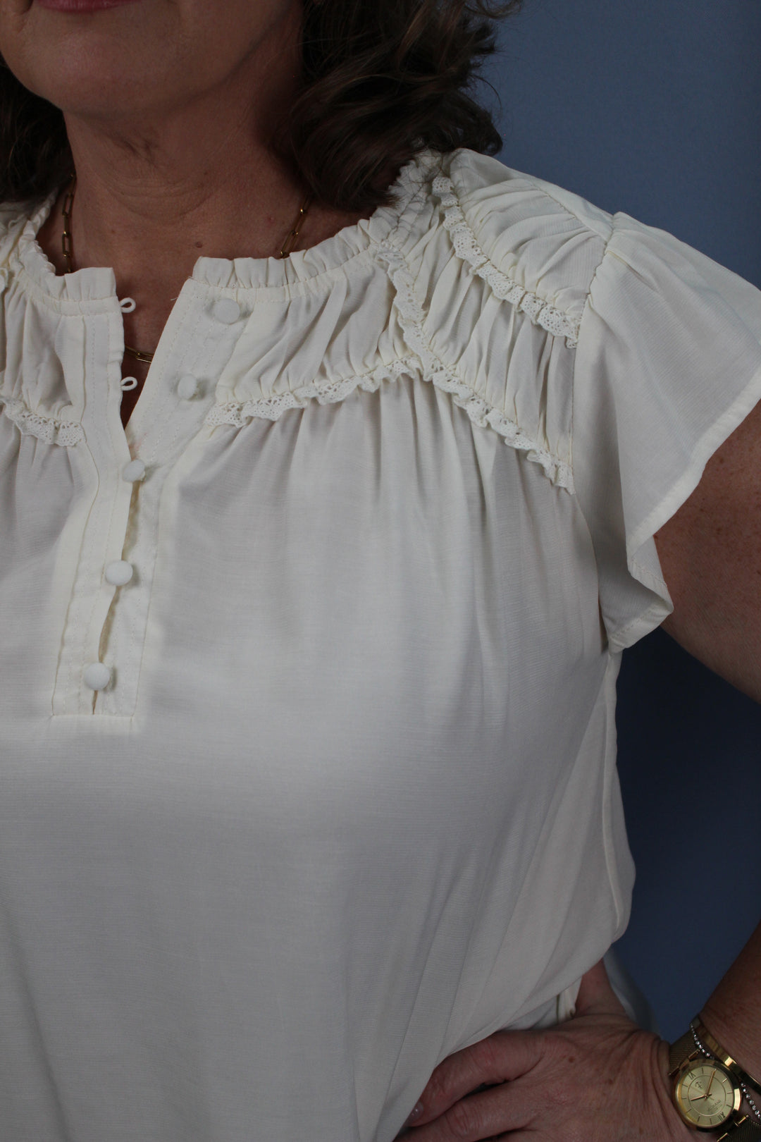RUFFLED YOKE SHORT SLEEVE HENLEY BLOUSE