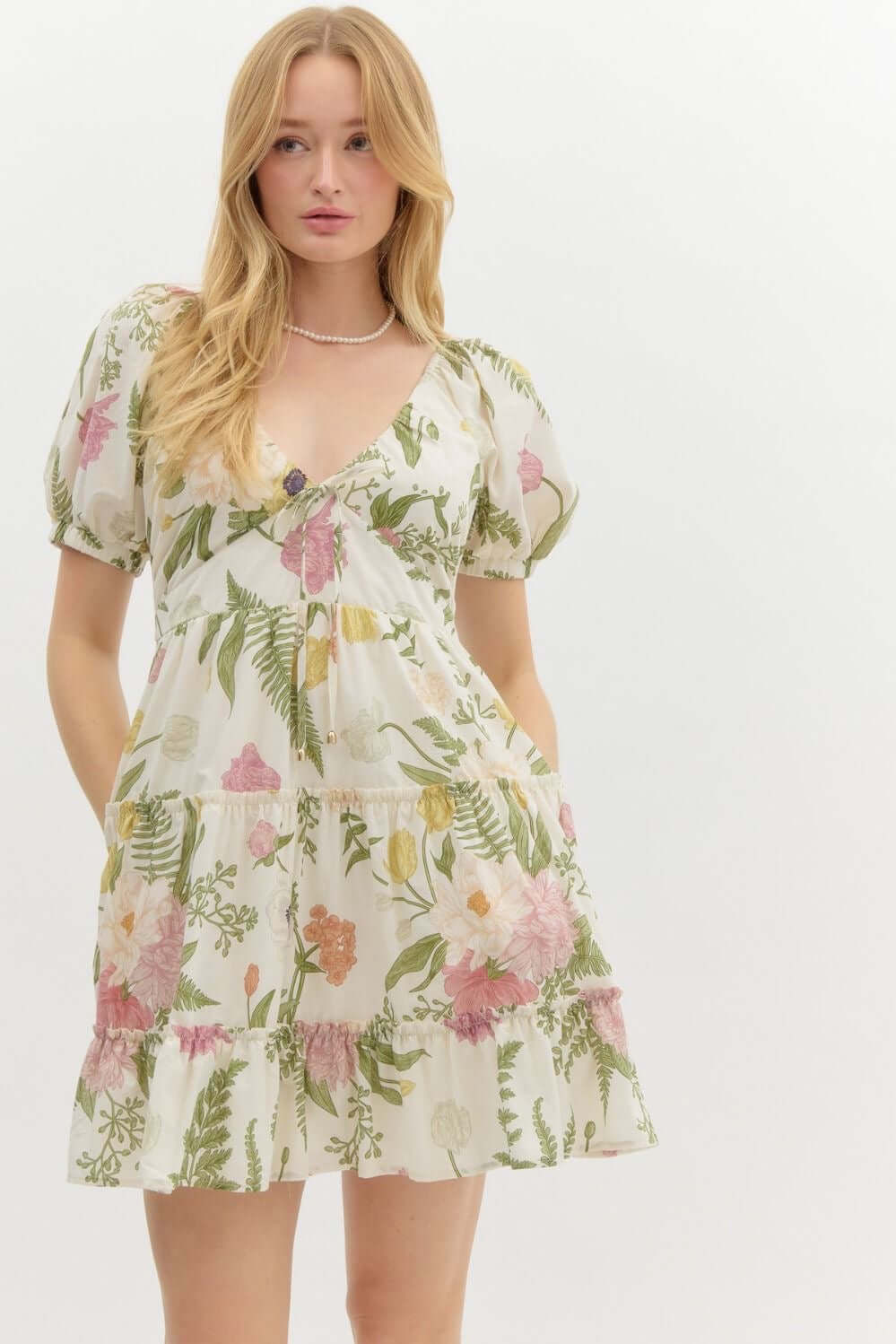 Mini dress with tropical flower print with a small puff sleeve and v neck