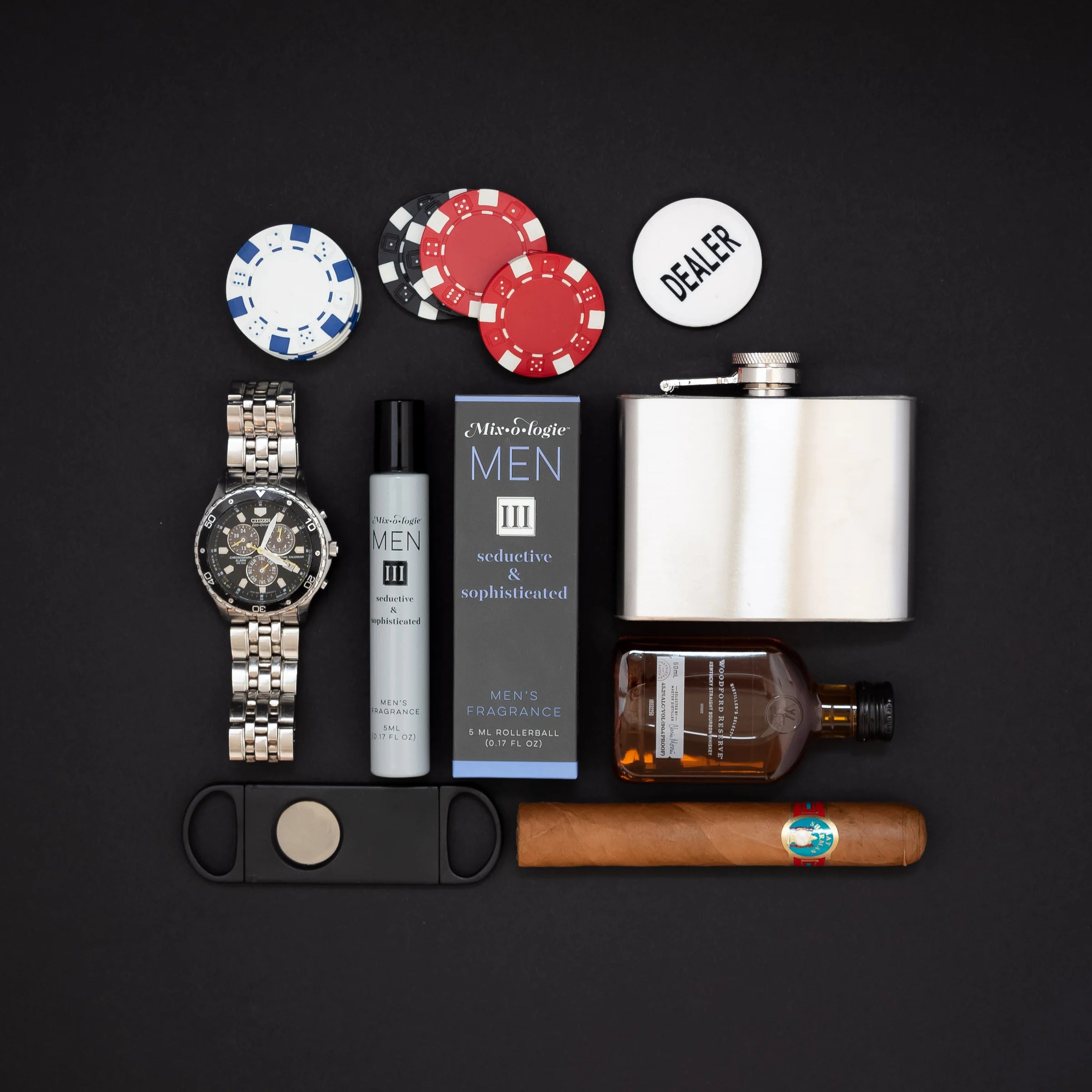 Collection of men's accessories and items including a watch, flask, cigars, and perfume on a black background.