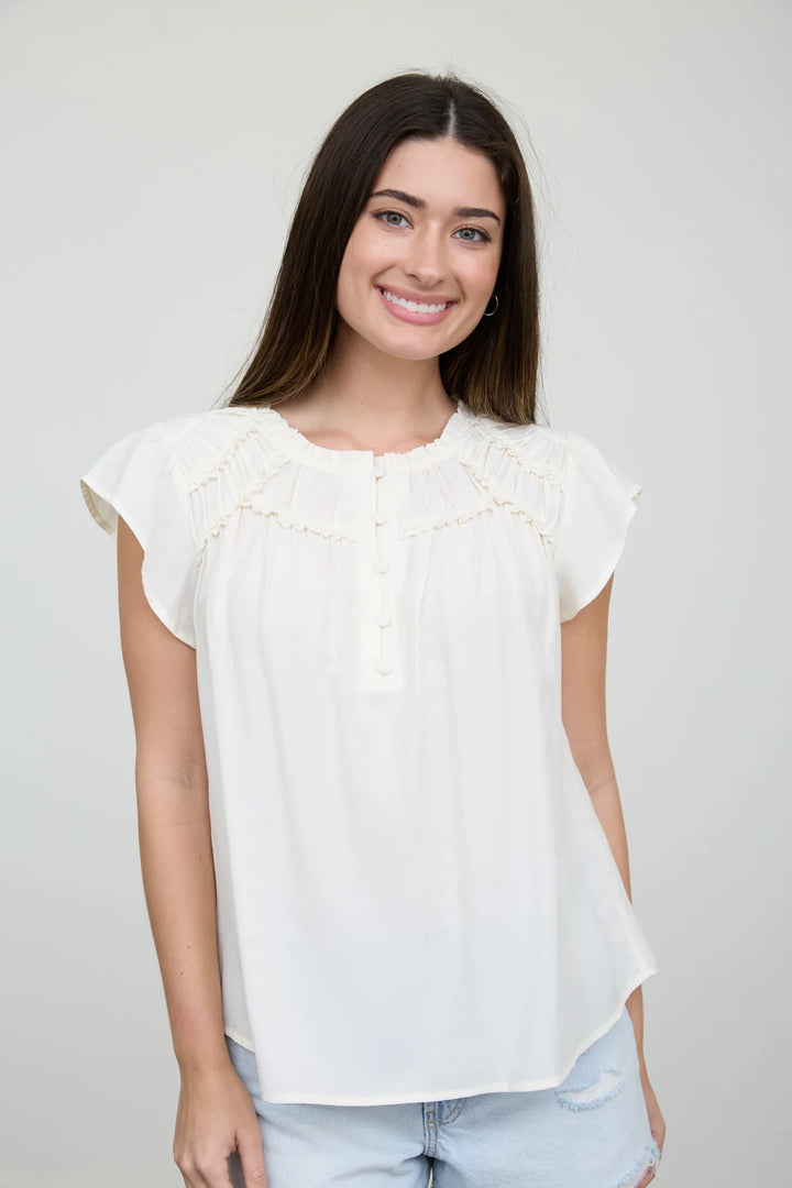 RUFFLED YOKE SHORT SLEEVE HENLEY BLOUSE