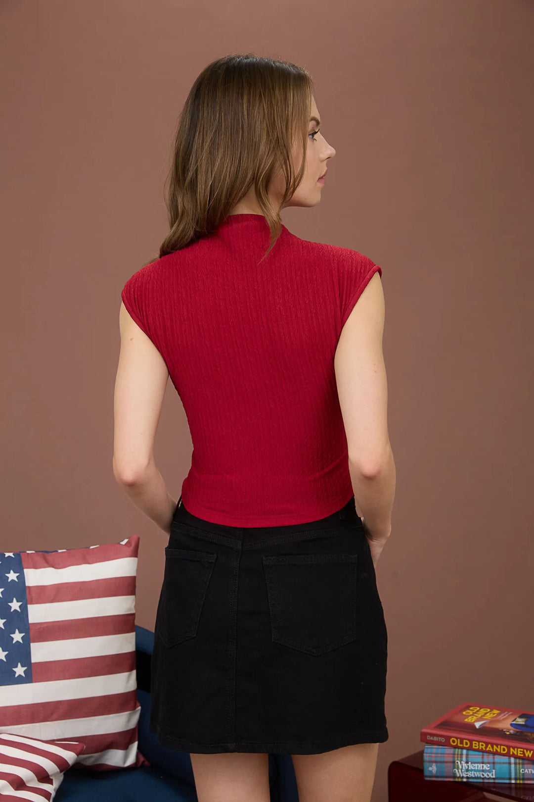 sleek mock neckline and a sleeveless silhouette